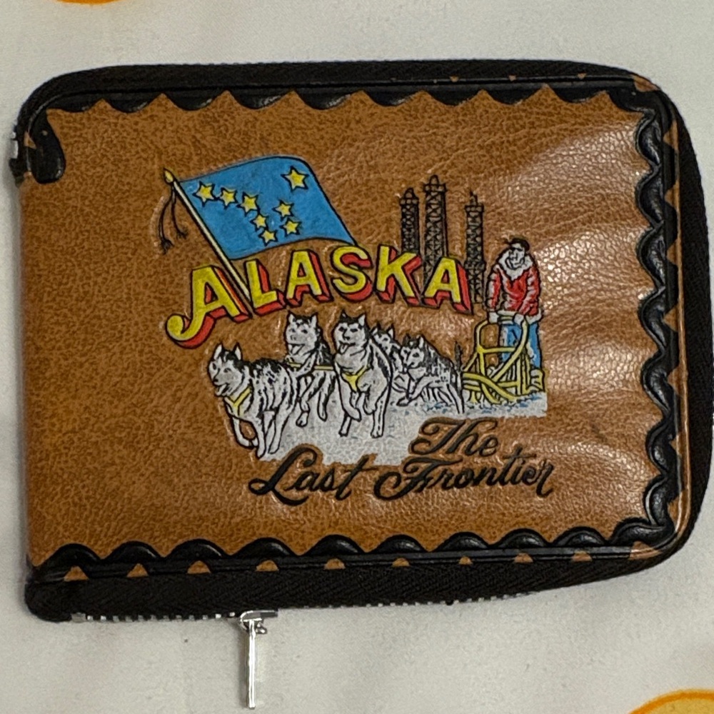 Alaska Themed Brown Wallet quite old with celebrity photos inside.